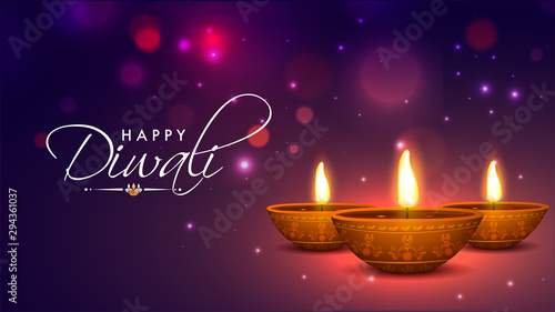 Realistic, Illuminated Oil Lamps on shiny bokeh background for Indian Festival of Diwali celebration.