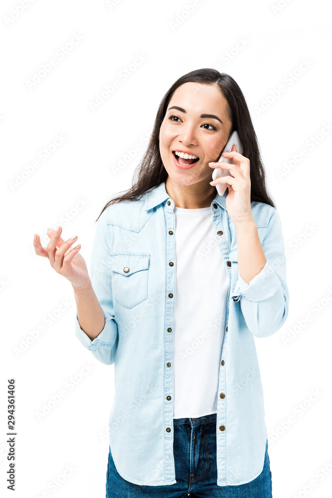 attractive and smiling asian woman in denim shirt talking on smartphone isolated on white attractive and smiling asian woman in denim shirt talking on smartphone isolated on white