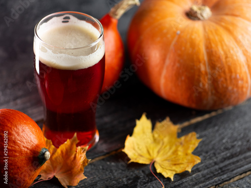 A glass of pumpkin ale on a wooden table photo