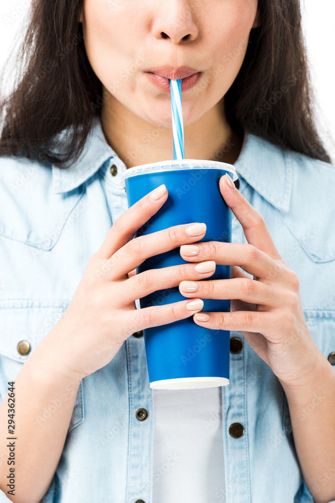 cropped view of woman in denim shirt drinking from plastic cup isolated on white cropped view of woman in denim shirt drinking from plastic cup isolated on white
