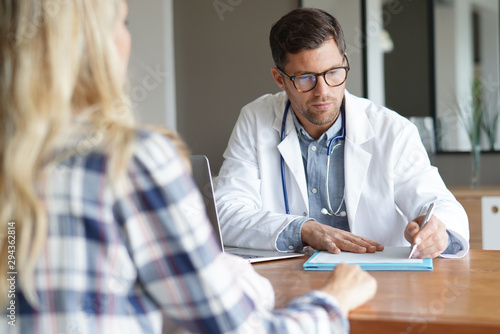 Doctor with patient in office photo