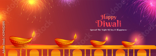 Illustration of illuminated oil lamps and fireworks on glossy background for Happy Diwali festival. Website header or banner design.
