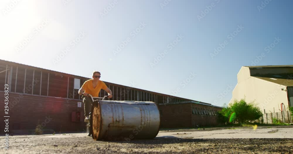 BMX rider doing trick in an empty yard BMX rider doing trick in an empty yard