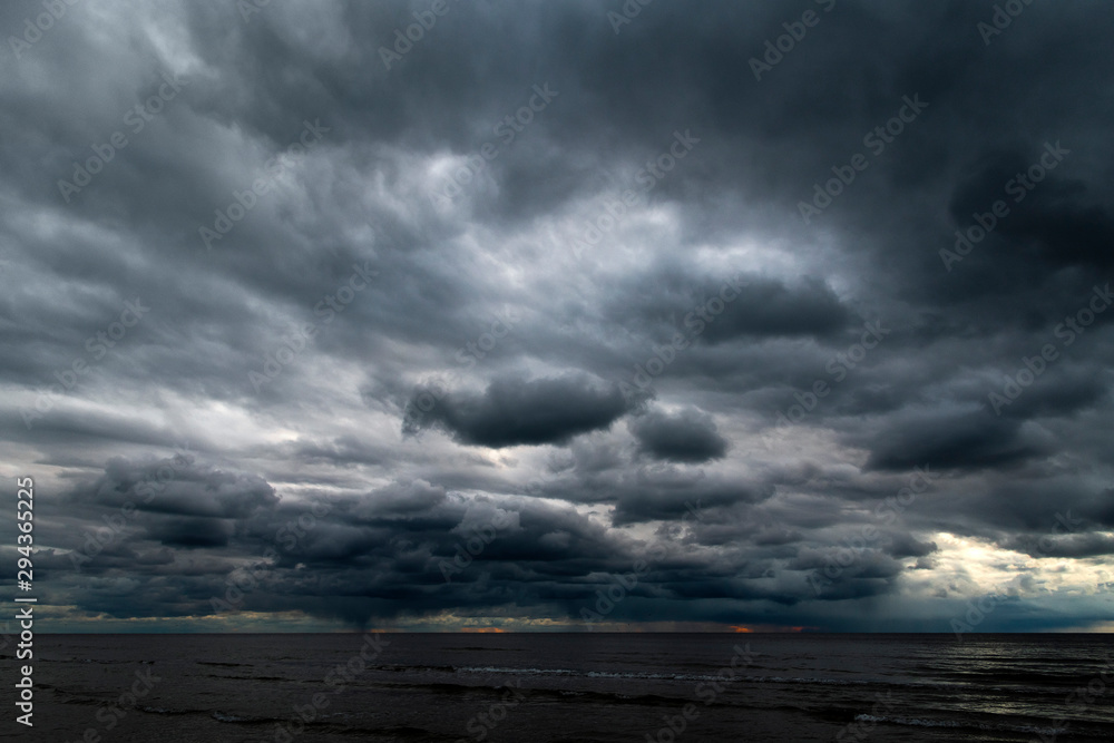 Dark clouds over Baltic sea. - obrazy, fototapety, plakaty 