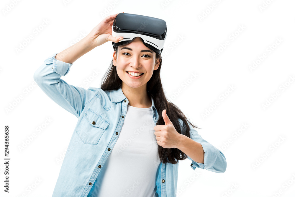 asian woman in denim shirt with virtual reality headset showing thumb up isolated on white asian woman in denim shirt with virtual reality headset showing thumb up isolated on white