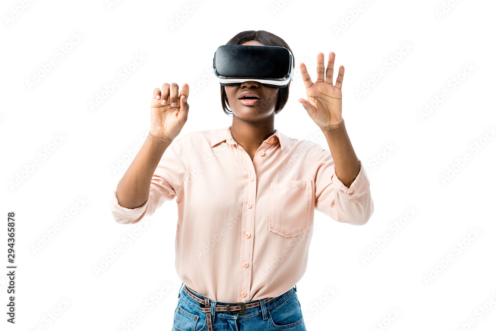 shocked african american woman in shirt with virtual reality headset showing hands isolated on white shocked african american woman in shirt with virtual reality headset showing hands isolated on white