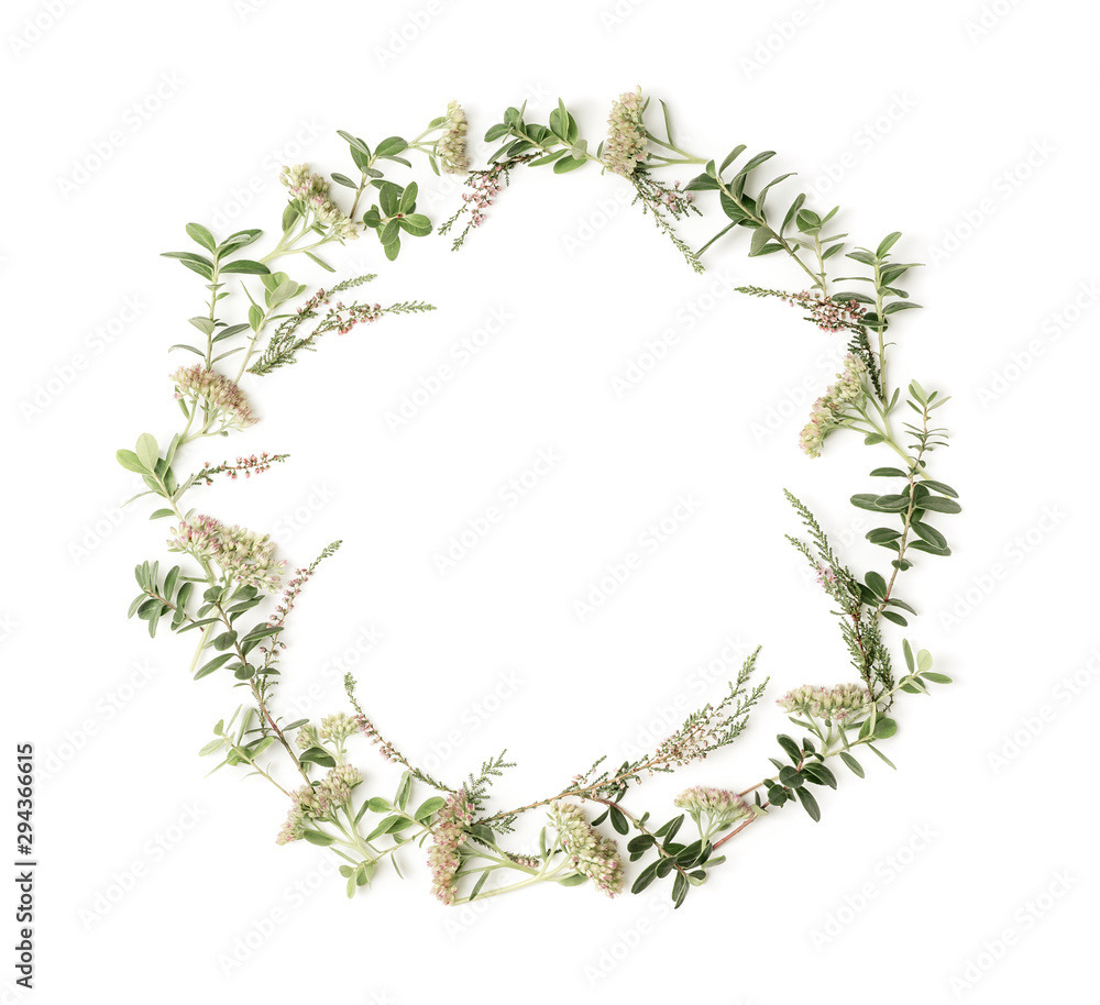 Wreath frame with pink flowers, heath, branches and leaves on white background. Flat lay style. Overhead view. Copy space. Wreath frame with pink flowers, heath, branches and leaves on white background. Flat lay style. Overhead view. Copy space.