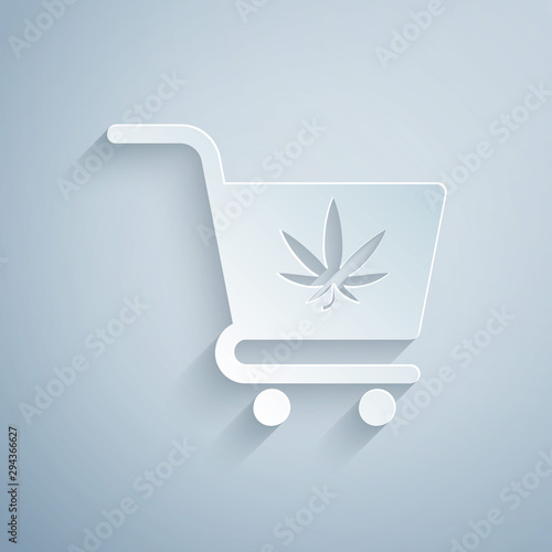 Paper cut Shopping cart with marijuana or cannabis leaf icon isolated on grey background. Online buying. Delivery service. Supermarket basket. Paper art style. Vector Illustration