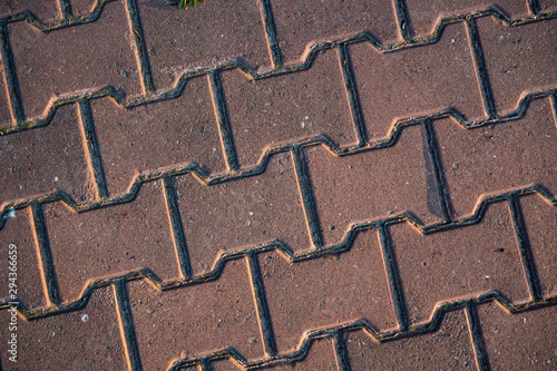 Texture of paving slabs overgrown with grass. Background image of a stratum stone