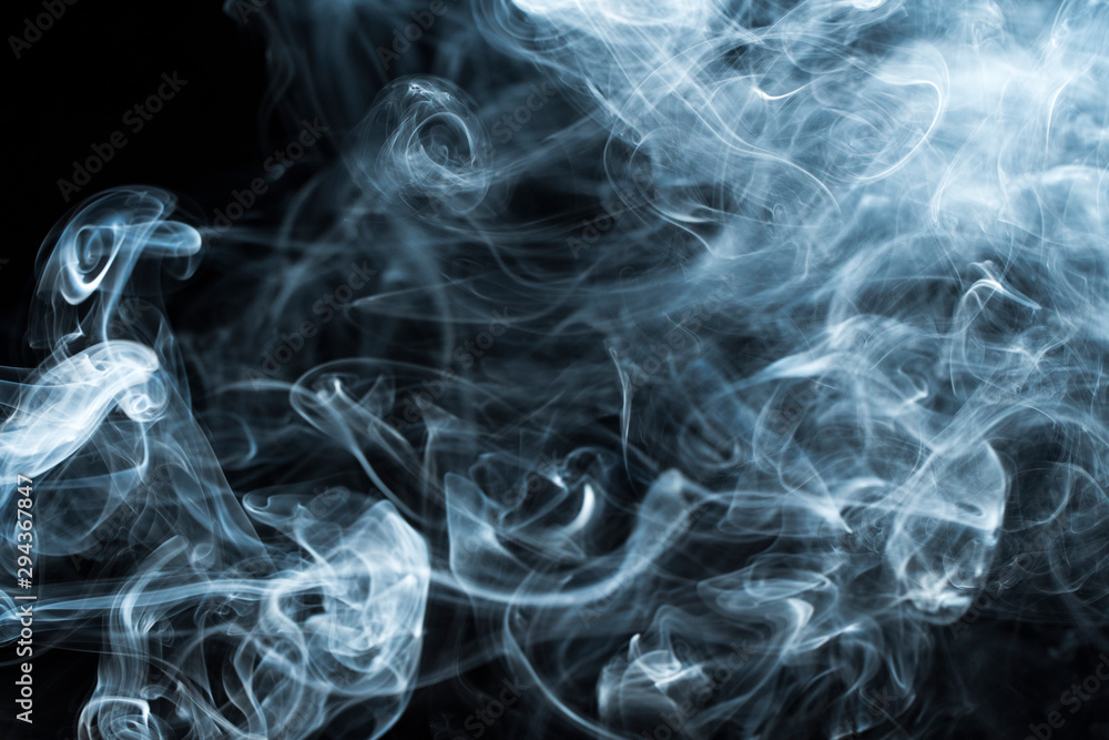 Photo of a wisp of smoke on a dark background Photo of a wisp of smoke on a dark background