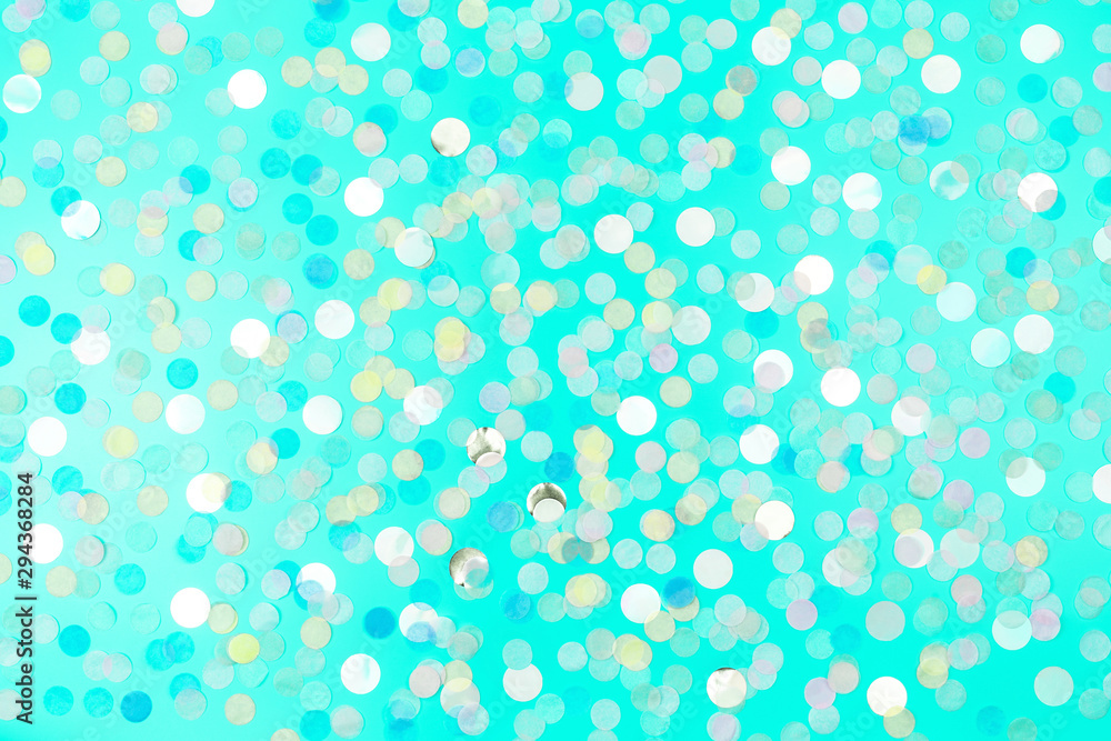 Festive background with round paper confetti in trendy mint color. Copy space. Holiday concept.