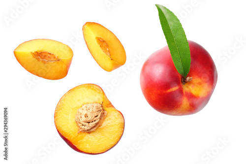 Nectarine with green leaf and slices isolated on white background. top view