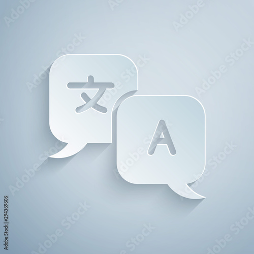 Paper cut Translator icon isolated on grey background. Foreign language conversation icons in chat speech bubble. Translating concept. Paper art style. Vector Illustration