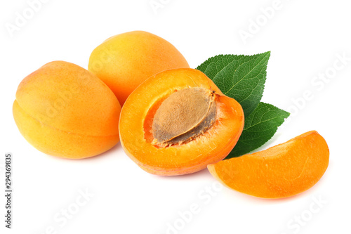 apricot fruits with slices and green leaf isolated on white background.