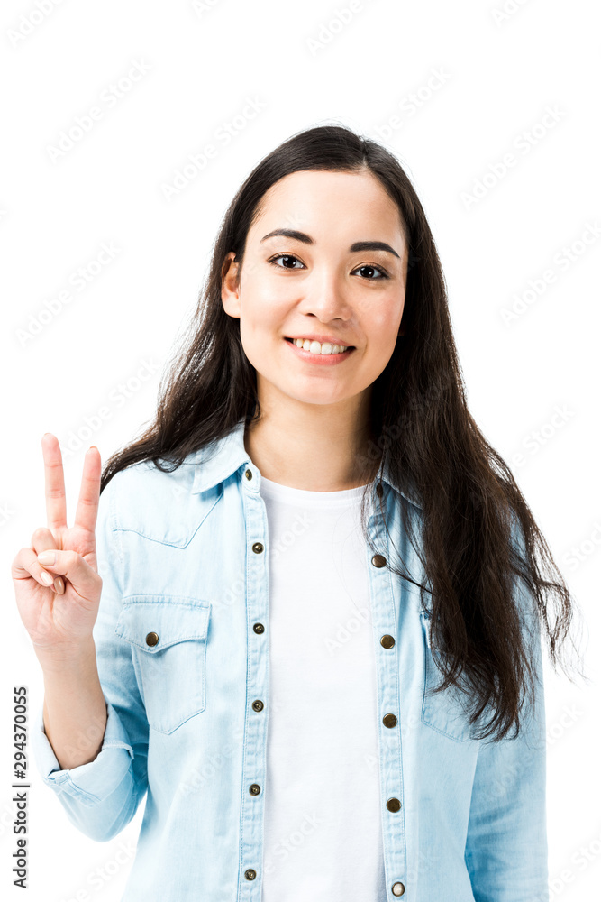 attractive and smiling asian woman in denim shirt showing peace sign isolated on white attractive and smiling asian woman in denim shirt showing peace sign isolated on white