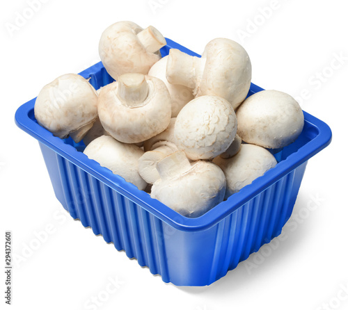 Fresh champignons in plastic packaging isolated on white background. Top side view. Clipping path.