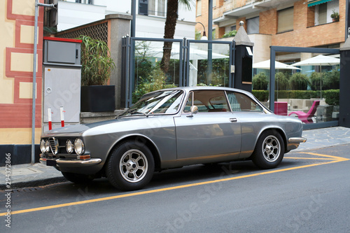 Картината върху платно Beautiful gray retro car parked by the road