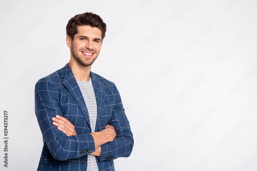 Turned photo of imposing youth cross his hands wear plaid outfit blazer jacket isolated over white background Turned photo of imposing youth cross his hands wear plaid outfit blazer jacket isolated over white background