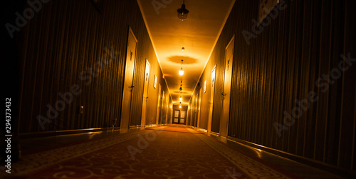 Fototapeta long dark vintage motel corridor with closed doors