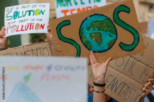 Fridays for future: students hands showing  banners and boards