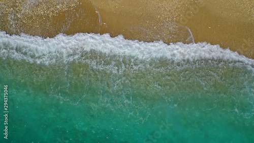 Aerial drone top down photo of tropical exotic sandy bay with emerald sea and waves