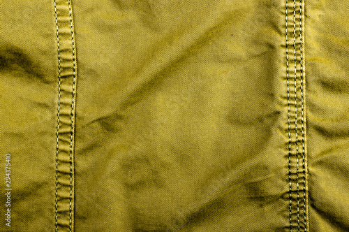 clothing items stonewashed cotton fabric texture with seams, clasps, buttons and rivets, macro