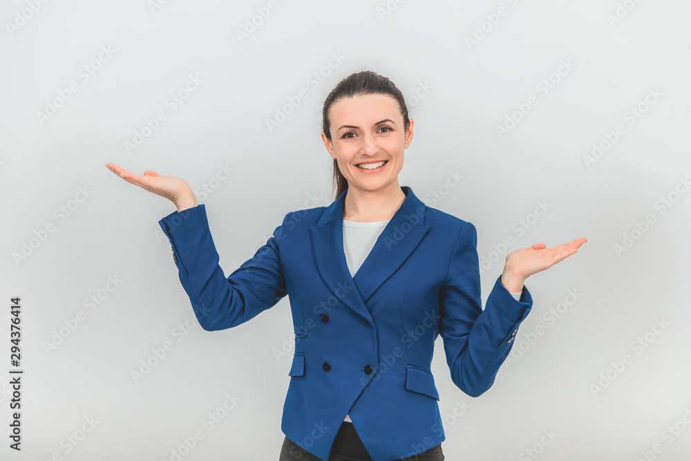 Beautiful teacher standing, raising her hands, holding palms opened for some product, smiling lovely. Beautiful teacher standing, raising her hands, holding palms opened for some product, smiling lovely.