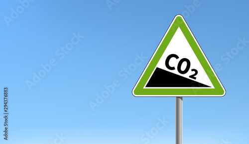 CO2 emission reduction sign green triangular shape blue sky