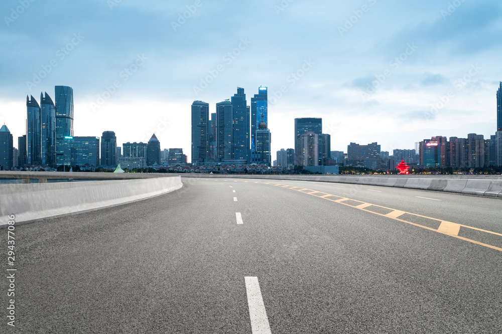 empty highway with cityscape and skyline of qingdao,China.