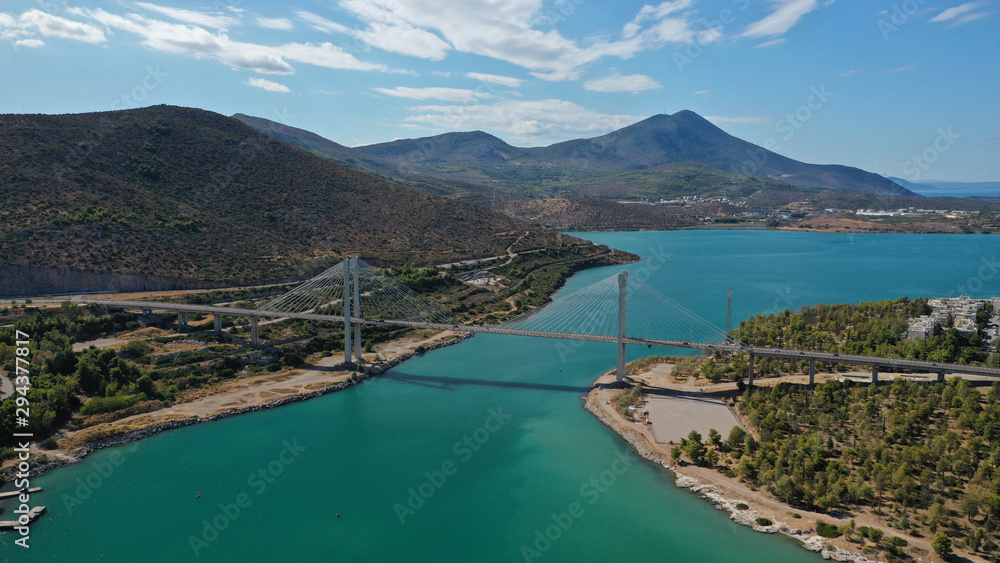 Aerial drone photo of famous new suspension bridge of halkida or Chalkida connecting mainland Greece with Evia island with beautiful clouds and blue sky, Greece