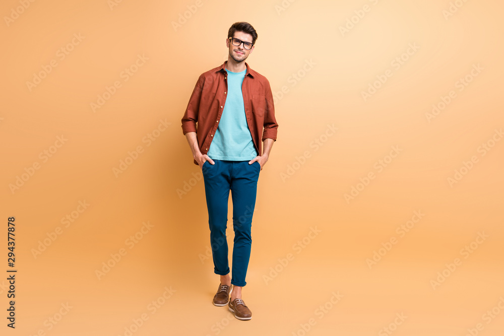 Full length body size view of his he nice attractive calm content brunet guy business shark leader partner expert holding hands in pockets isolated over beige color pastel background Full length body size view of his he nice attractive calm content brunet guy business shark leader partner expert holding hands in pockets isolated over beige color pastel background