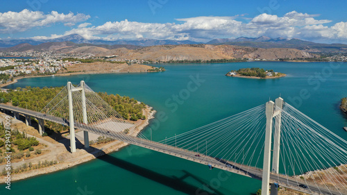 Aerial drone photo of famous new suspension bridge of halkida or Chalkida connecting mainland Greece with Evia island with beautiful clouds and blue sky, Greece