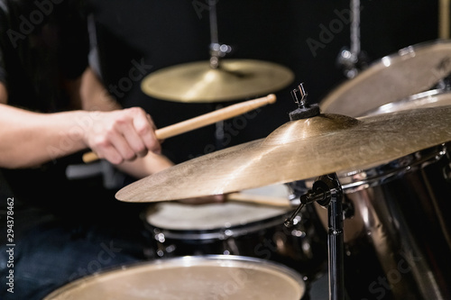 Close up of cymbal and man hand holding drumstick