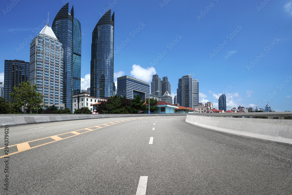 empty highway with cityscape and skyline of qingdao,China.