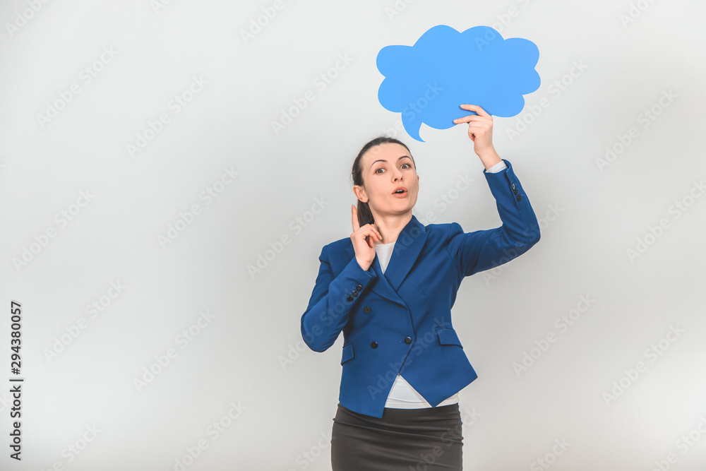 Female teacher standing, raising up blue speech bubble and pointing her finger up, looking up with thoughtful face expression. Female teacher standing, raising up blue speech bubble and pointing her finger up, looking up with thoughtful face expression.