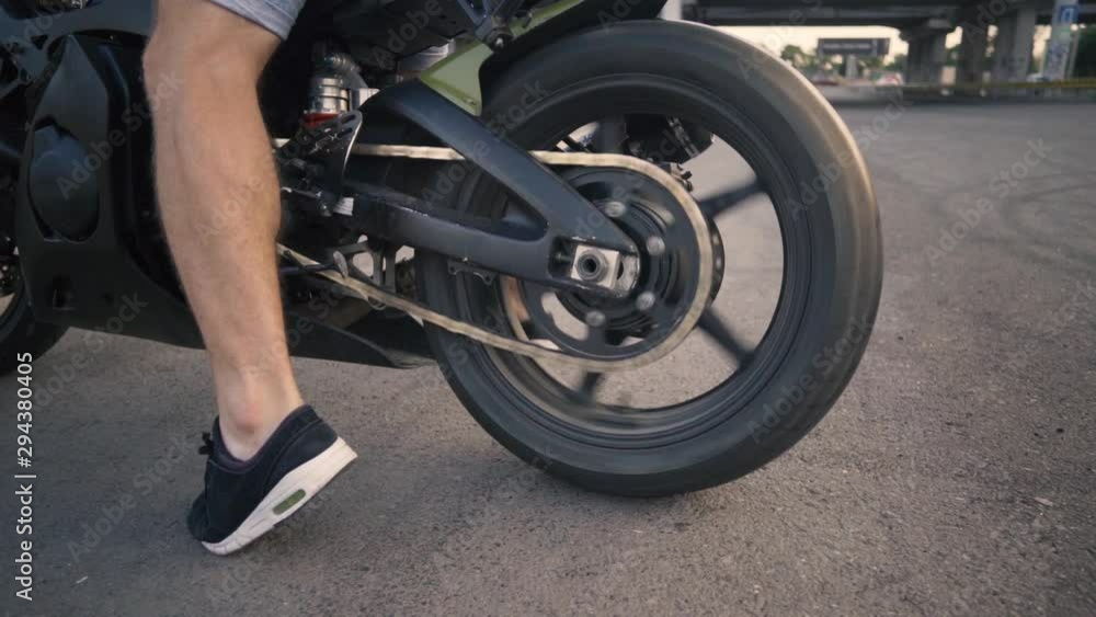 Motorcyclist doing tire burnout on a custom motorcycle, slow motion. Professional motorcyclist drift and turns on a motorcycle on the asphalt, a biker does a trick Motorcyclist doing tire burnout on a custom motorcycle, slow motion. Professional motorcyclist drift and turns on a motorcycle on the asphalt, a biker does a trick