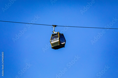 Cable car flying on the mountain.