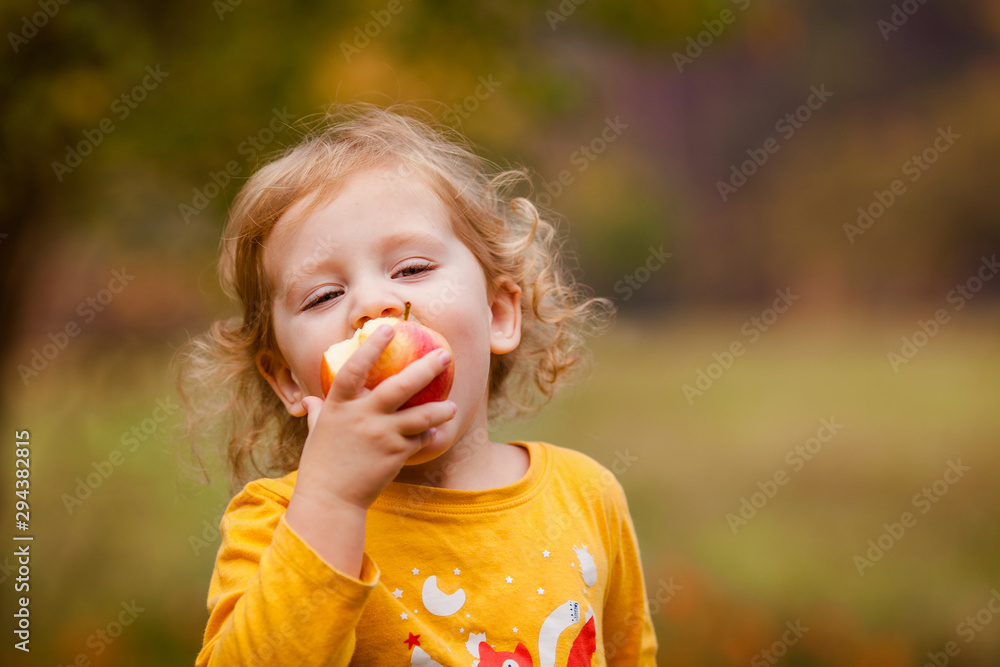 Cute little girls eating red delicious apple Cute little girls eating red delicious apple