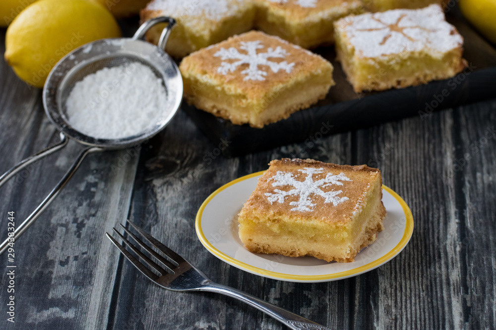 Lemon squares with snowflake icing sugar design.