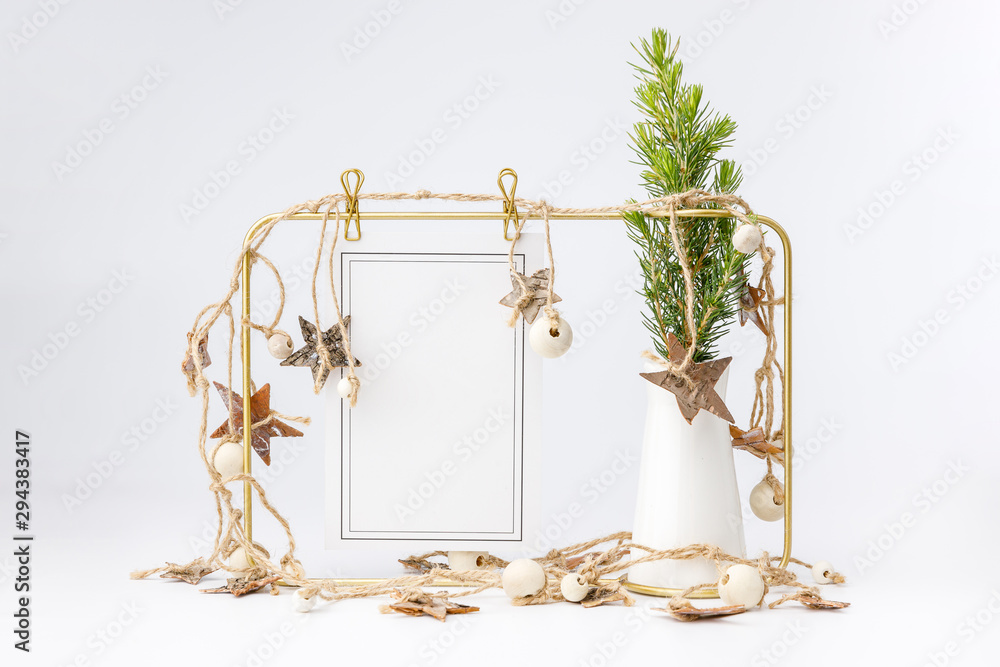 Little fir tree in ceramic vase and golden frame on white background. Christmas card - toys, garlands and wooden thinks. Little fir tree in ceramic vase and golden frame on white background. Christmas card - toys, garlands and wooden thinks.