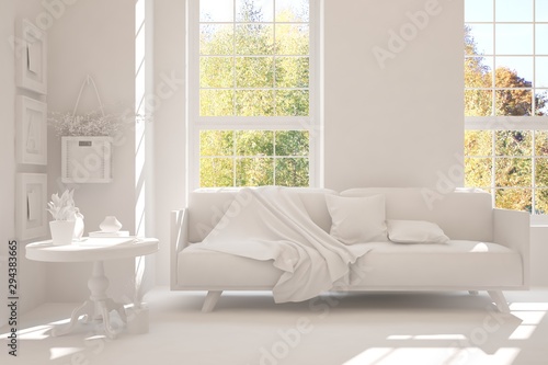 Stylish room in white color with sofa and autumn landscape in window. Scandinavian interior design. 3D illustration