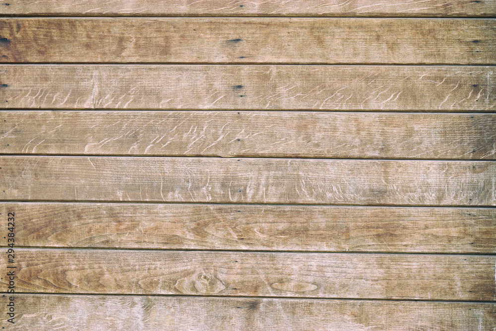 Old wooden background with horizontal brown boards. Wooden background, painted surface brown boards. Weathered brown wood background texture. Old wooden background with horizontal brown boards. Wooden background, painted surface brown boards. Weathered brown wood background texture.