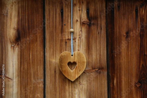 Wooden heart for happiness on wooden doors