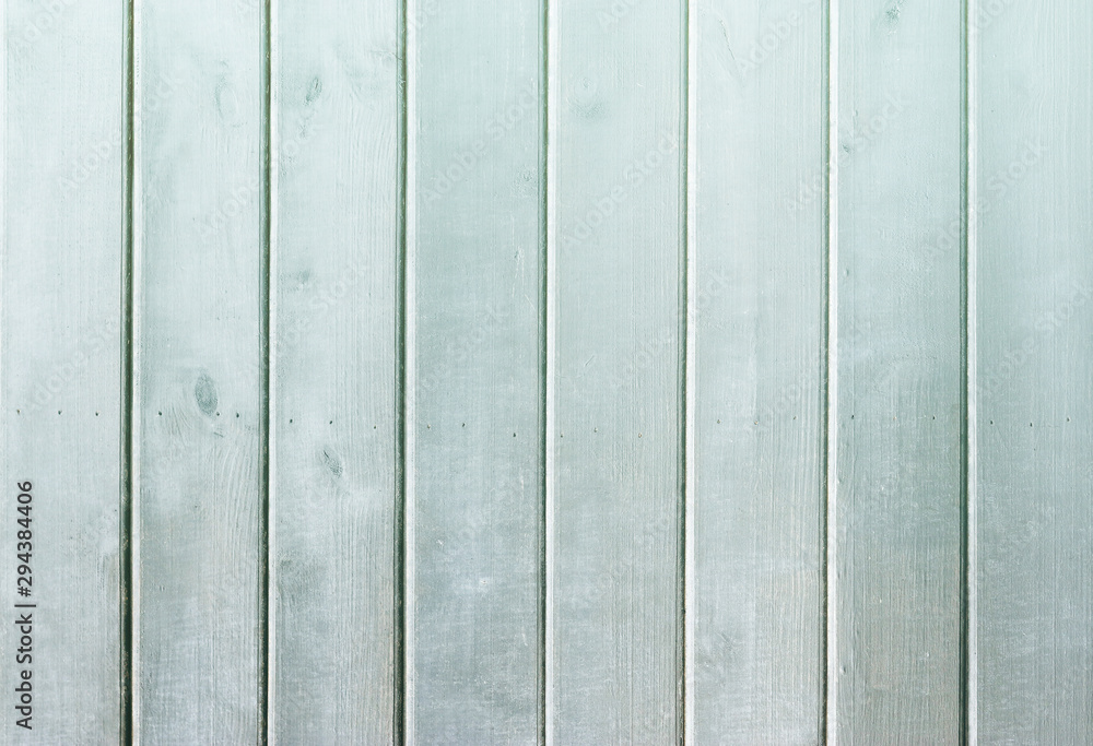 Fototapeta premium Light-blue wooden background. Blue faded painted wooden texture, background, wallpaper. Wooden background, painted surface blue boards. Weathered blue wood background texture. Vertical planks