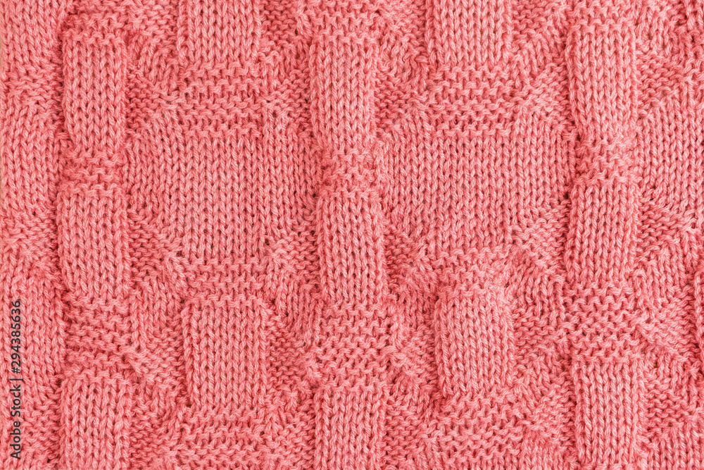Pink knitted soft blanket. Knitted pink background. Top view. Pink knitted soft blanket. Knitted pink background. Top view.