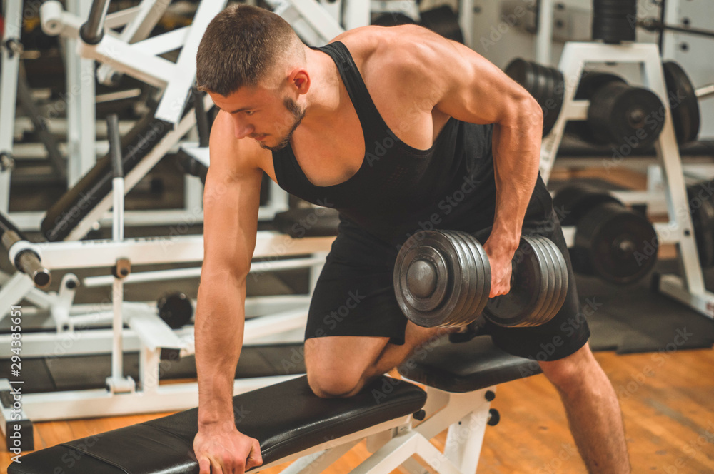 Fitness instructor in the sport room background. Male model with muscular fit and slim body. Sport concept Fitness instructor in the sport room background. Male model with muscular fit and slim body. Sport concept