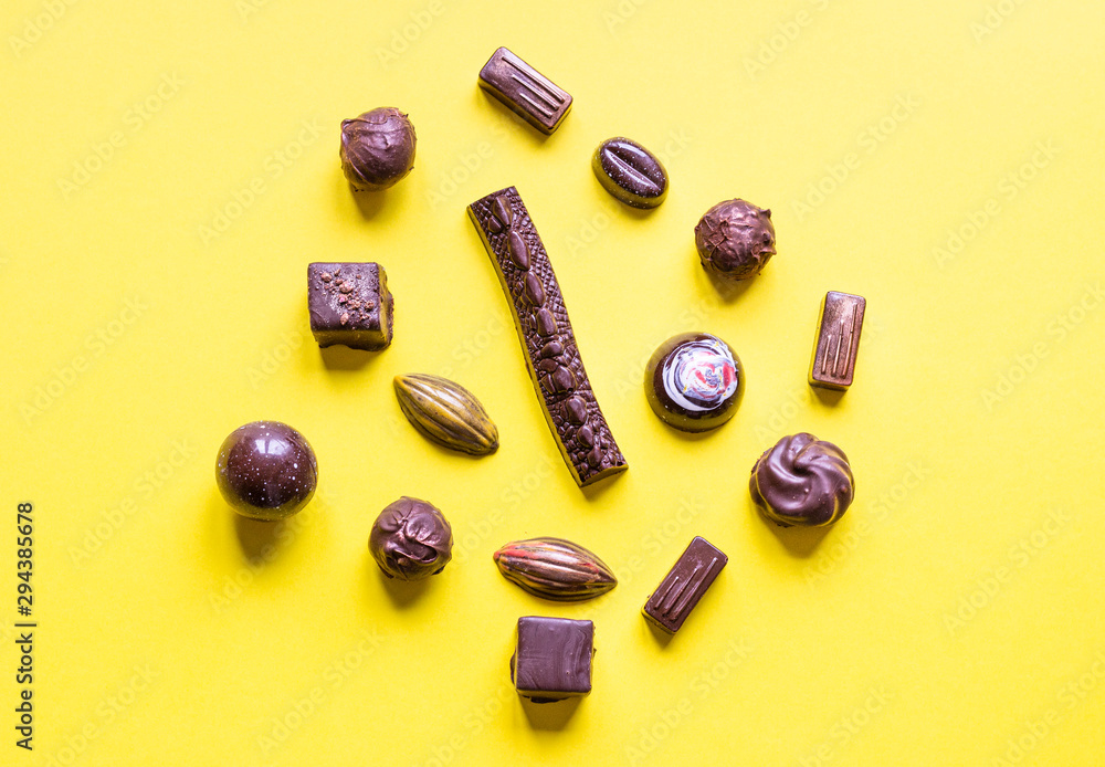 Delicious chocolate candies on yellow paper background. Delicious chocolate candies on yellow paper background.