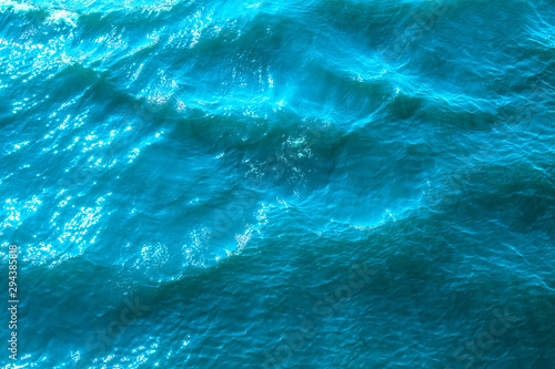 Blue sea surface with sunlight, top view © artmim
