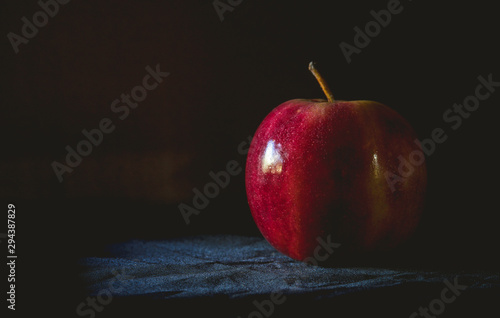 still life red apple in dark moody