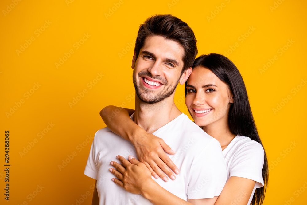 Photo of amazing pair in love posing for family portrait piggyback wear casual white t-shirts isolated yellow color background Photo of amazing pair in love posing for family portrait piggyback wear casual white t-shirts isolated yellow color background